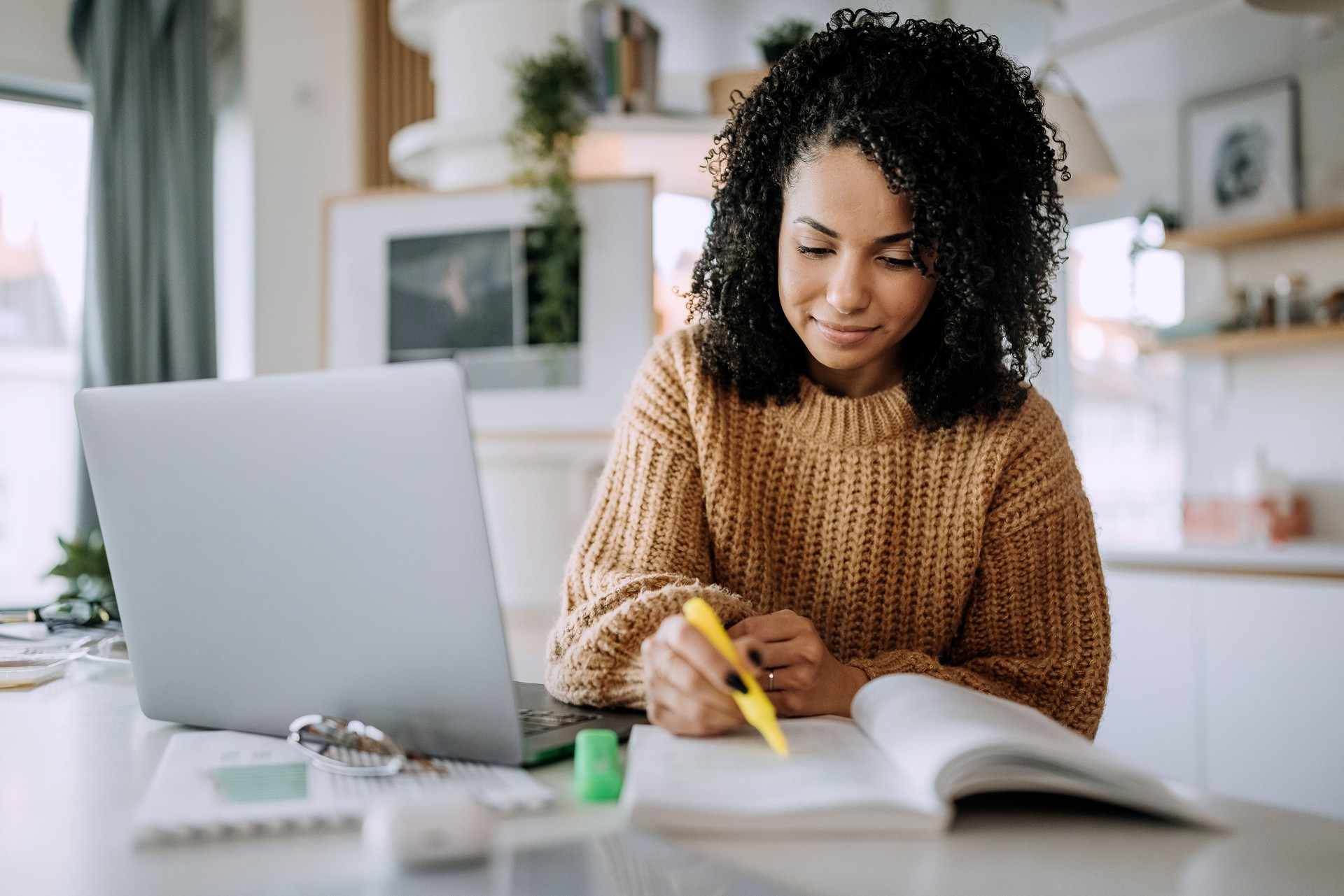 Young beautiful woman studying at home